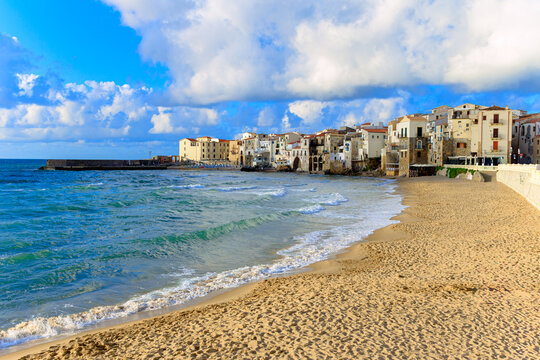 Scenic Italian coastal town with sandy beach and sparkling blue sea waves waterfront district of a historic place
