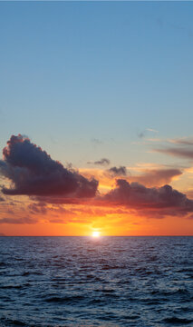 breathtaking sunset illuminating the sea beneath colorful clouds creates a serene atmosphere