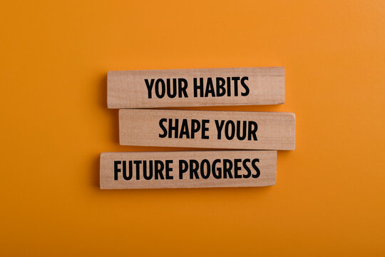 Wooden blocks with a message about habits shaping future progress, symbolizing personal growth, behavior change, motivation, discipline, and positive life development.