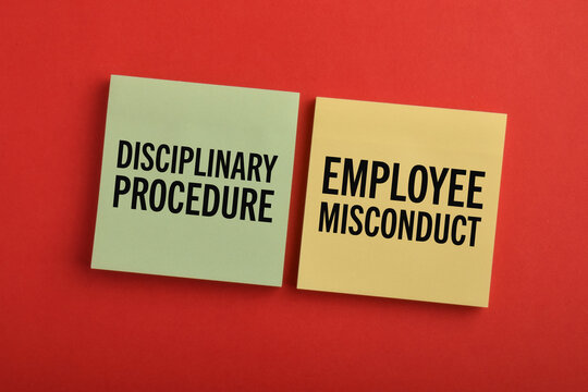 Sticky notes labeled disciplinary procedure and employee misconduct on a red background, illustrating workplace discipline, HR policy, compliance, and employee management.