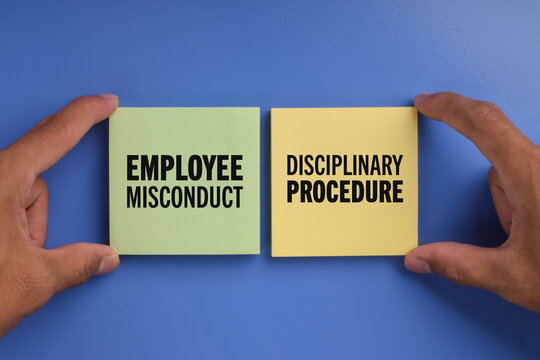 Wooden blocks showing employee misconduct and disciplinary procedure, representing workplace violations, employment rules, HR management, and organizational accountability.