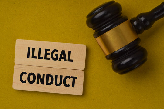 Wooden blocks labeled illegal conduct beside a judge's gavel, symbolizing unlawful behavior, criminal offenses, legal violations, justice, and law enforcement.