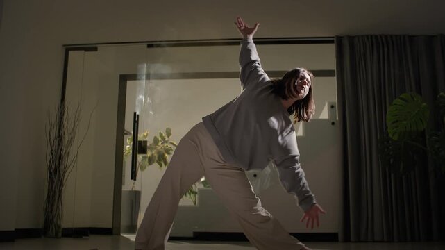 Deep side backbend yoga stretch in modern living room with warm sunlight and calm home wellness mood
