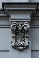 Obraz premium Architecture and classical design, ornate stone capital on a building facade with intricate scrollwork and floral relief details in a historic city