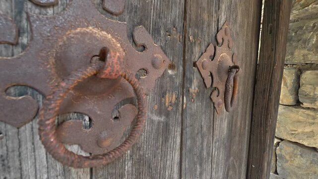 Ancient door knocker on old gate of traditional Chinese dwelling  Traditional Chinese antique metal door knocker on ancient gate