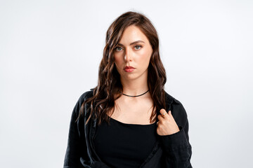 Obraz premium Serious brunette woman in black shirt studio portrait