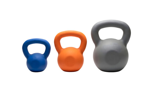 Three kettlebells of different sizes and colors are lined up against a transparent background.