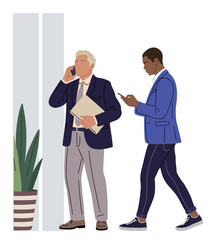 Obraz premium Two men in business attire stand near a potted plant. One man speaks on a phone, holding documents. The other walks beside him, checking a device