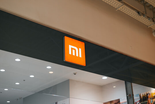 Mi store sign is prominently displayed in a contemporary shopping mall. Bright lighting enhances the visual appeal of the retail space surrounding the logo