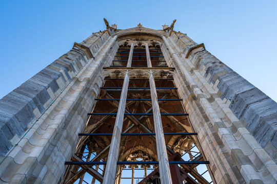 Bell tower in marble of ancient gothic church viewed from the bottom