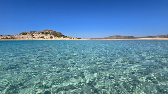 Sparkling turquoise waters of Simos Beach in Elafonisos, Greece on a sunny day