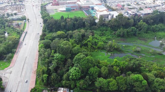 Aerial view wetland Cordoba and Suba road in middle cars moving Bogota, Colombia 4k