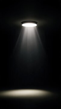 A solitary spotlight illuminates an empty dark space, creating a dramatic effect