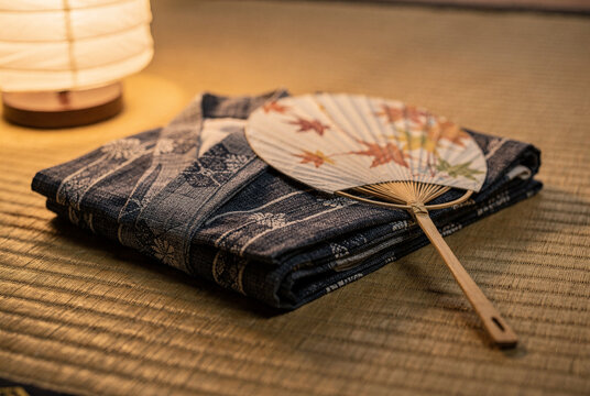 Traditional Japanese Yukata and Folding Fan on Tatami Mat