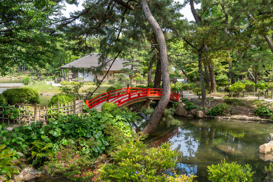 Red bridge in Shukkei-en Japanese garden in Hiroshima, Japan