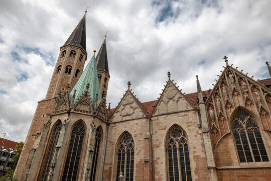 Braunschweig, Germany - July 3, 2026: Elaborate Gothic stonework, pointed windows and a central entrance decorate the exterior of St. Martini Church.