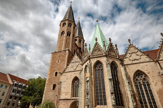 Braunschweig, Germany - July 3, 2026: Elaborate Gothic stonework, pointed windows and a central entrance decorate the exterior of St. Martini Church.
