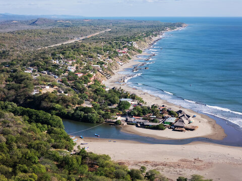 Ocean coastline with houses on cliff in Nicaragua landscape