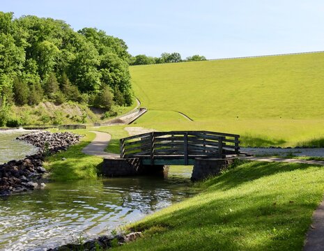 The old wood bridge in the park on a sunny day.