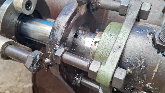Close-up of portable line boring machine setup and heavy machinery fabrication in a workshop for industrial repair concept