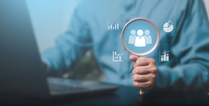 HR, recruitment, teamwork, business analysis, management and workforce strategy. Businessman analyzing a team icon through a magnifying glass with financial charts and performance indicators.