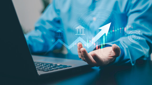 Financial and banking concept, investment, banking, trading, financial goals, growth and economic success. Target, upward trend and digital market chart, business professional using a laptop.