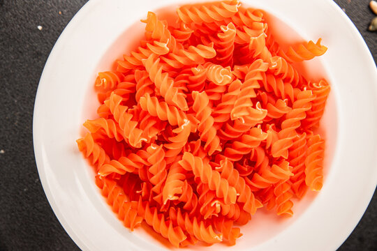 Red lentil pasta fusilli gluten-free fresh pasta healthy eating tasty snack gourmet, rustic food background on the table top view copy space  vegetarian and vegan food