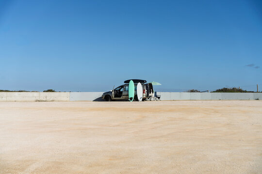 Auto mit Surfbrettern am Strand &ndash; Roadtrip, Surfen und sommerliche Freiheit