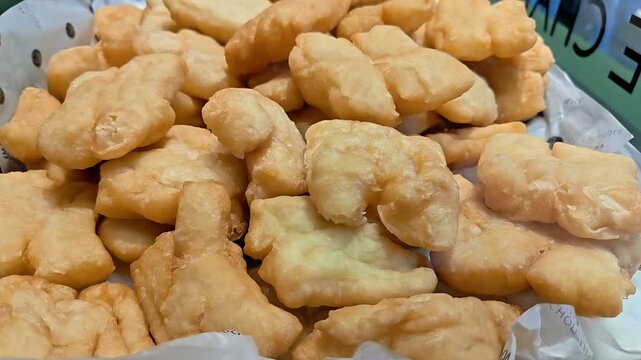 Pile of Pa Thong Ko Yo Youtiao crispy deep fried wheat bread dough sticks on market stall, Local Thai Chinese Fast food, Local Cuisine, Asian Donut Dessert, Slow Motion