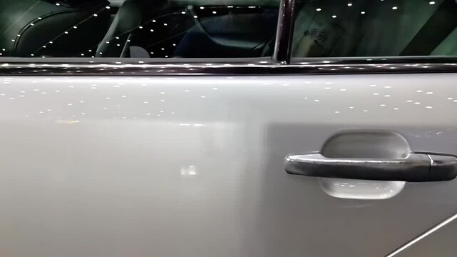 Glossy skin of grey silver color car door exterior, Automobile Dealership, Transportation Maintenance, Auto Bodywork Shop, Slow Motion Panning