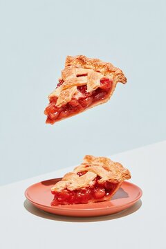 Floating slice of lattice fruit pie with a sugared crust above a plate, featuring a weightless and appetizing look for bakery campaigns with copy space