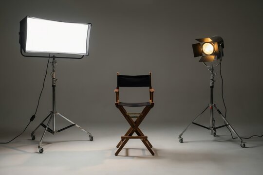 Director chair with studio lighting equipment on a grey background