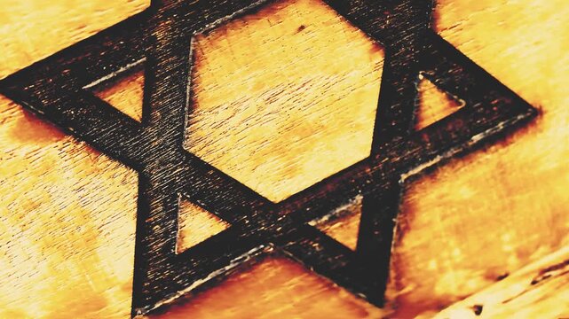 Dark carved Star of David symbol rests on a light wood surface texture