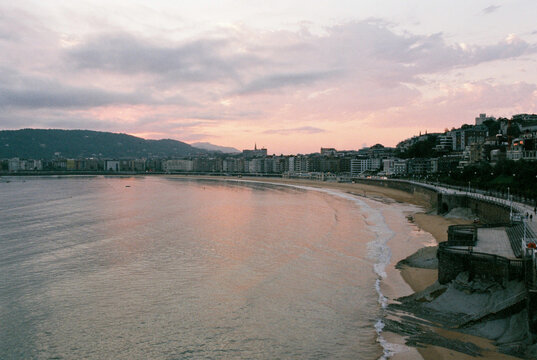 Sweeping view of a curved coastal city bay of San Sebastian city.