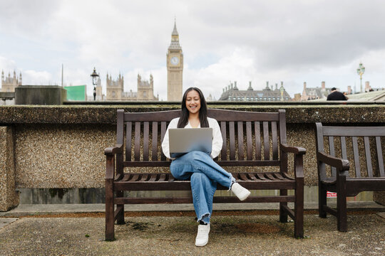 Smiling freelancer using laptop at London Big Ben