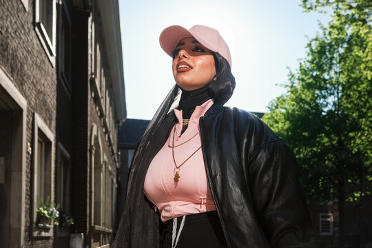 Woman in pink cap and leather coat