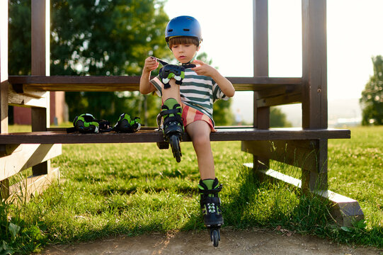 Child Putting on Rollerblade Protection