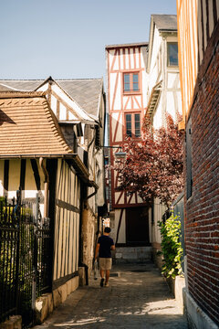 Walking Down a Narrow Street in a Historic Town on a Sunny Day
