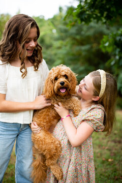 Happy Sisters With Their Dog
