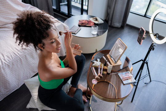 Influencer filming a makeup tutorial at home