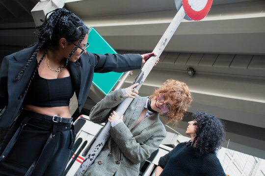 Group of Friends Having Fun Near a Street Sign in the City