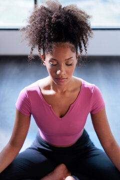 Young woman meditating peacefully in a yoga pose