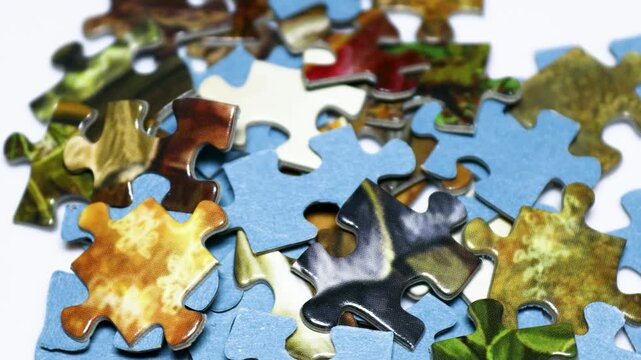 A collection of puzzle pieces stacked on a table
