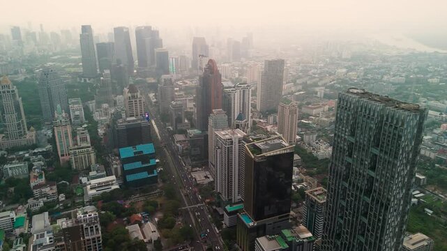 Grand modern architecture defines the horizon of Bangkok as endless urban streets weave through the famous skyline of this vibrant Thai capital city