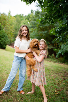 Happy Sisters With Their Dog