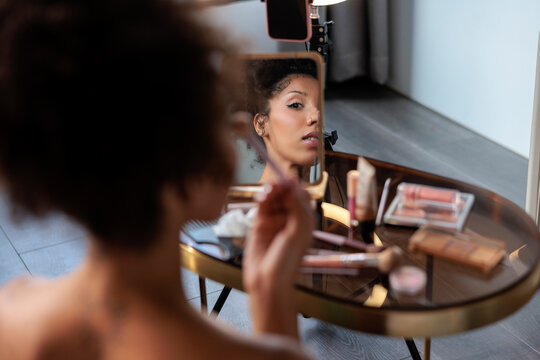 Woman filming a beauty makeup tutorial for social media