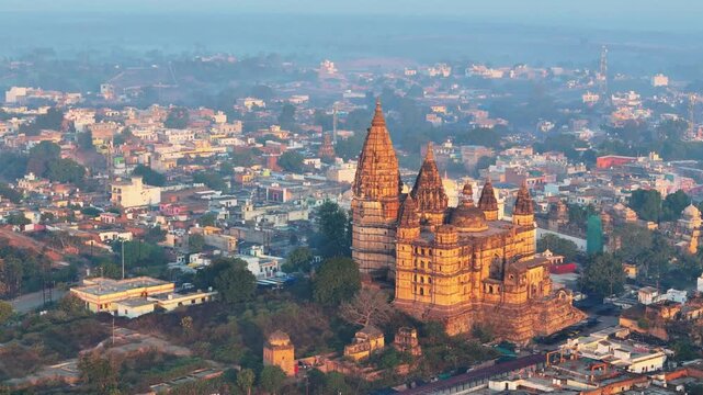 Smooth cinematic drone orbit around Chaturbhuj Temple in Orchha, Madhya Pradesh, revealing its towering architecture, historic surroundings and expansive urban landscape of Bundelkhand.
