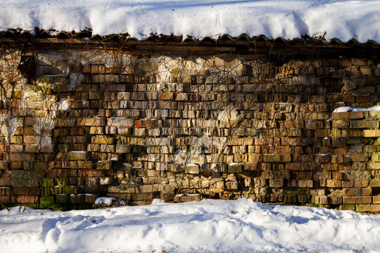Old abandoned brick wall in winter. Architectural detail.