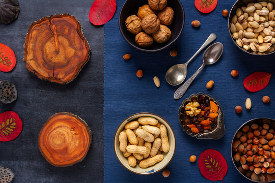 Food themed still life with crockery, various nuts and tea. Flat lay. Top view.