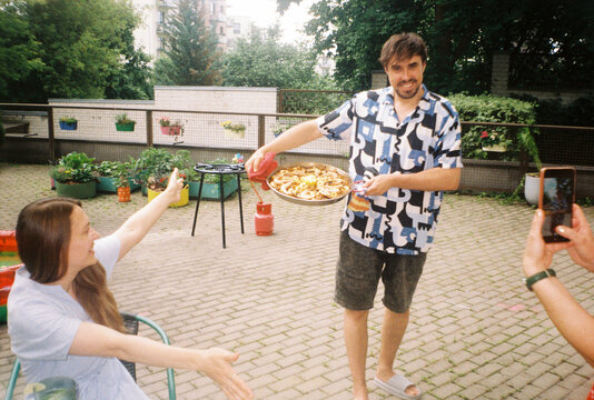 Man Bringing Paella To The Guests